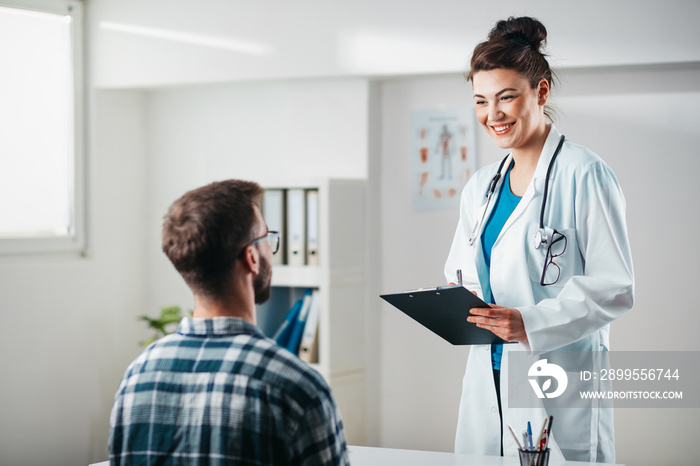 Woman Doctor reads results to Young Patient