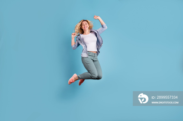 Full body photo of pretty lady raising arms wearing pants trousers isolated over blue background