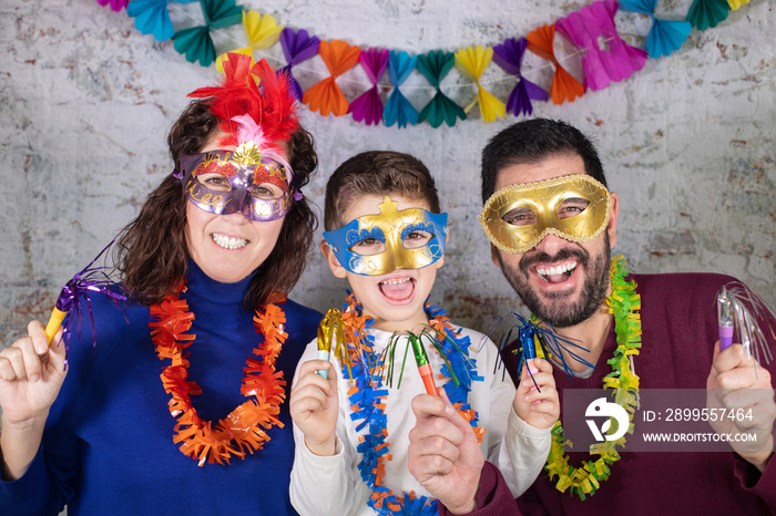 Happy family with masks celebrating Carnival