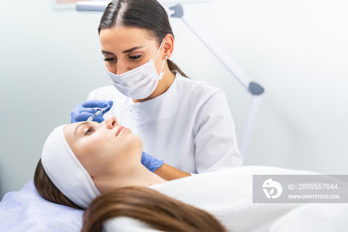 Dermal filler being injected into a patient forehead