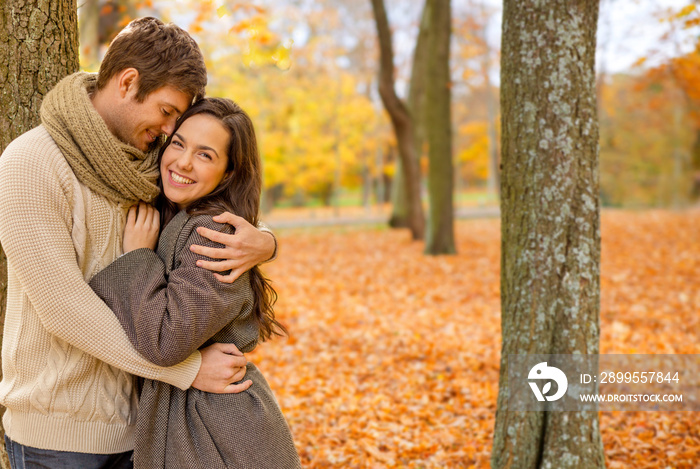 love, relationship, family and people concept - smiling couple hugging in autumn park