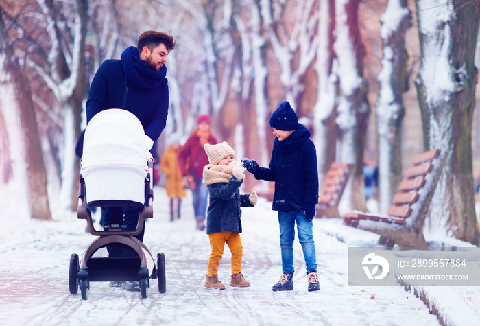 happy family, father with kids walking on the winter street