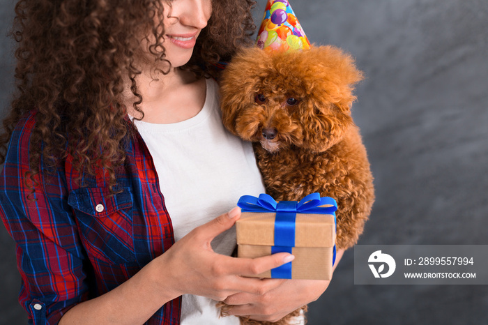 Young woman and her dog celebrate birthday