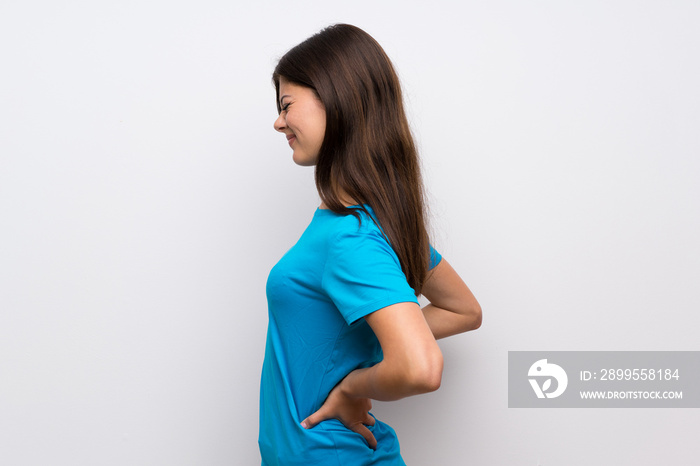 Teenager girl with blue shirt suffering from backache for having made an effort