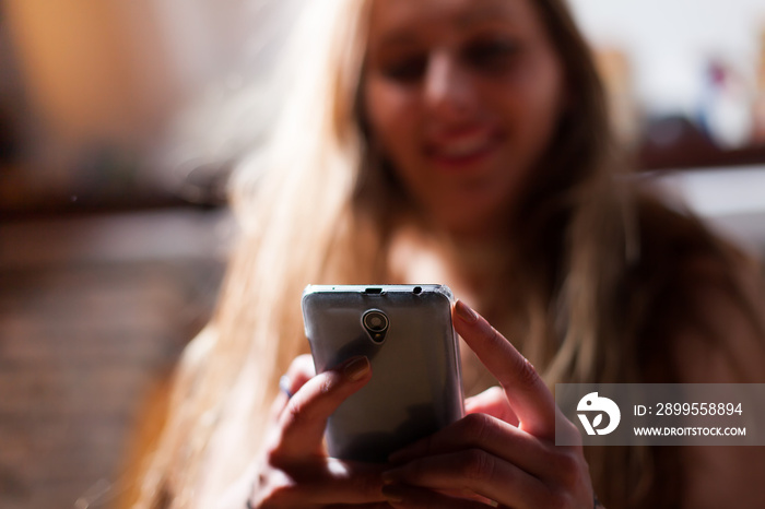 young woman texting on smartphone