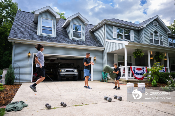 Air Force service member trains with his sons in a morning workout in preperation for a PT fitness test.