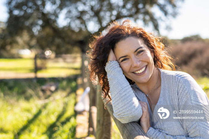 Happy Woman Smiling At Camera In A Field