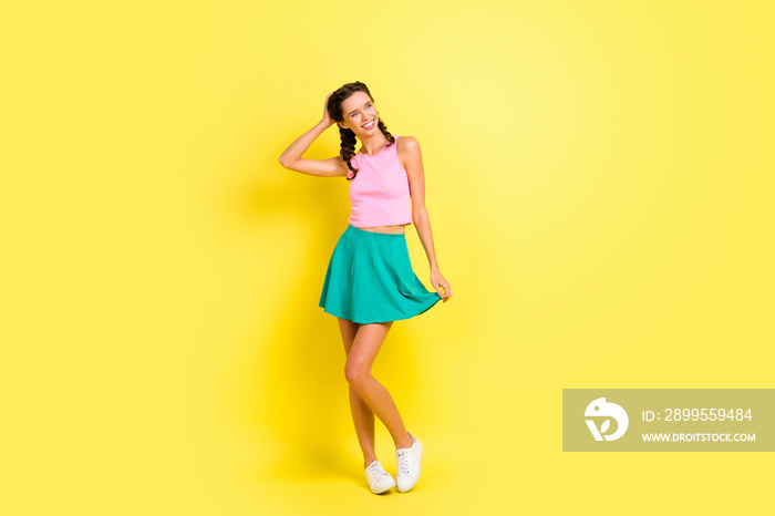 Full size photo of charming stunning young woman hold hair bottom green skirt summer isolated on yellow color background