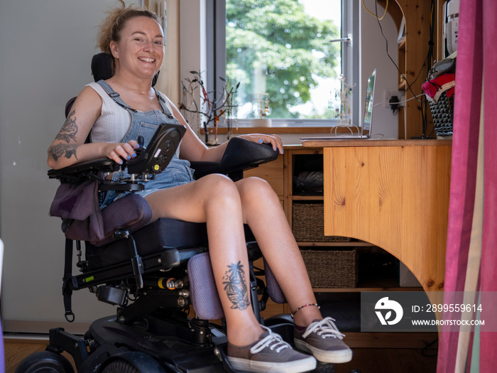 Portrait of smiling woman in electric wheelchair