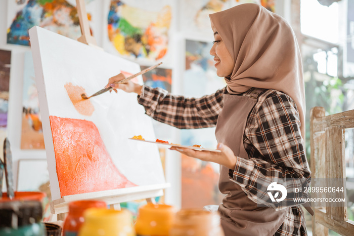 muslim female painter artist, painting on canvas