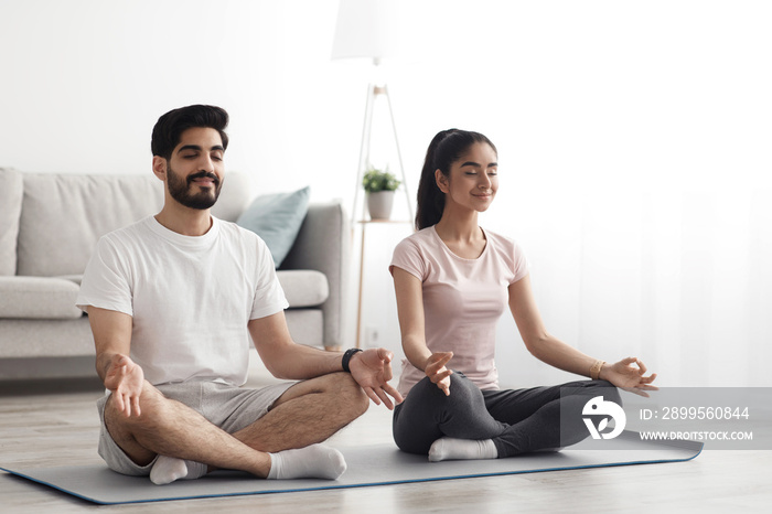 Happy couple doing exercises on quarantine at home, self-isolation together, stretching, exercise, health care at home