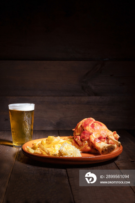 Traditional German cuisine roasted ham hock, sauerkraut and Beer, Oktoberfest background. High quality photo