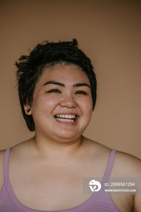 closeup portrait of a plus size filipino woman smiling