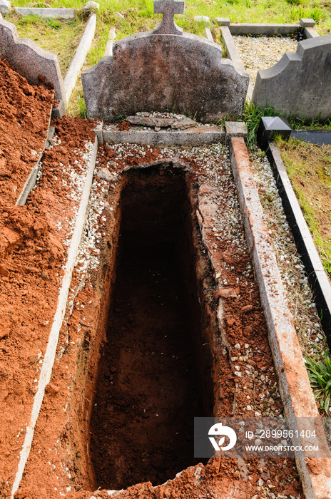 Open grave, freshly dug and awaiting burial.