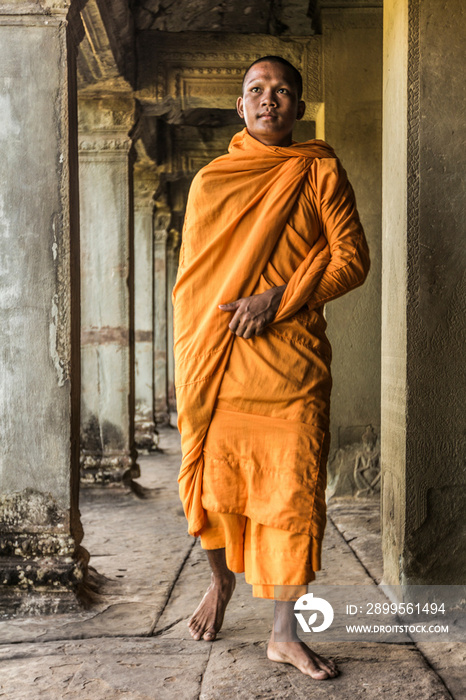 Young Buddhist monk walking through temple, Angkor Wat, Siem Reap, Cambodia