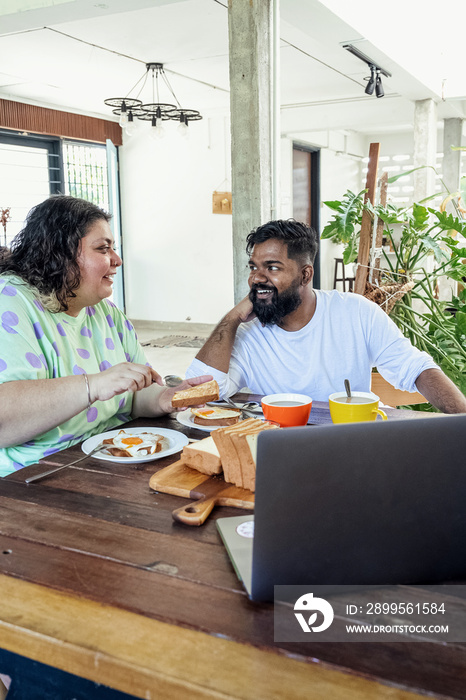 Couple making breakfast together at home in the morning