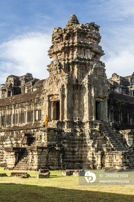 Young Buddhist monk standing at temple in Angkor Wat, Siem Reap, Cambodia