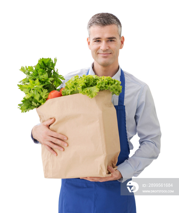 Shop assistant holding a grocery bag