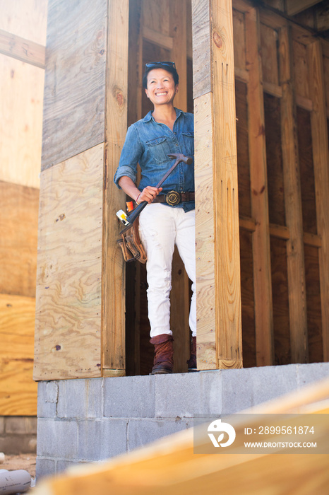 Portrait of mid adult woman building her own home