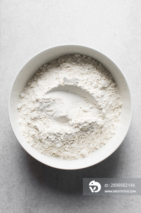 All purpose flour in a white bowl, baking flour in a large bowl