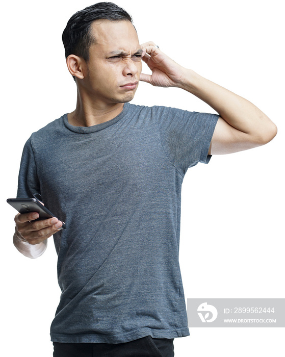 Young handsome asian man using smartphone on gray background