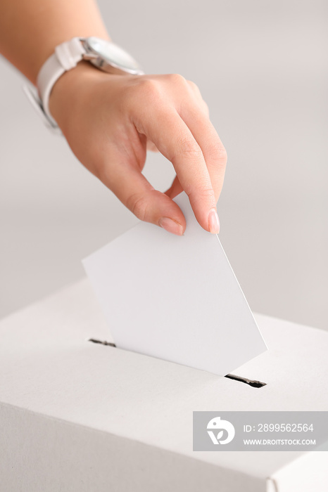 Voting woman near ballot box