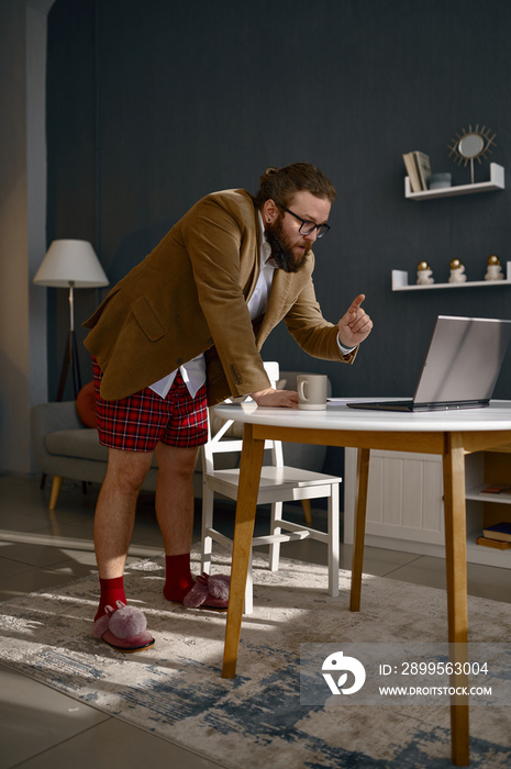 Excited eccentric man freelancer holding video conference