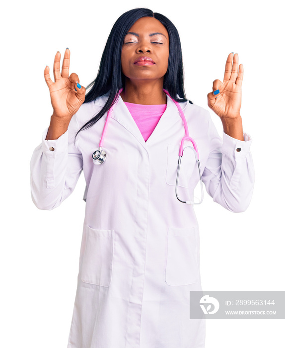 Young african american woman wearing doctor stethoscope relaxed and smiling with eyes closed doing meditation gesture with fingers. yoga concept.