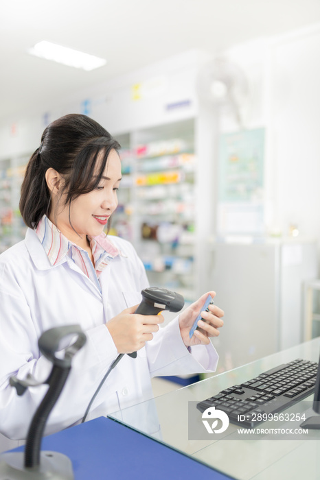 asian female pharmacist use barcode scanner in drugstore, medication management technology