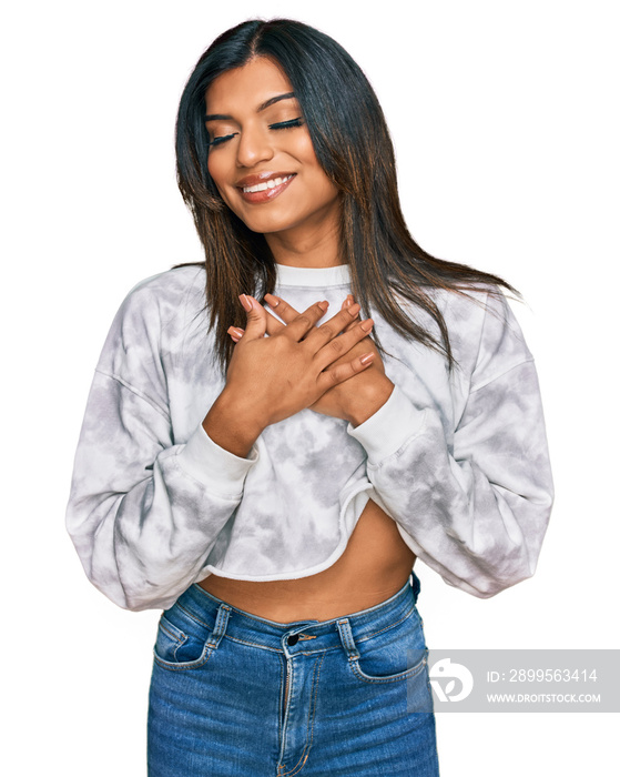 Young latin transsexual transgender woman wearing casual clothes smiling with hands on chest with closed eyes and grateful gesture on face. health concept.