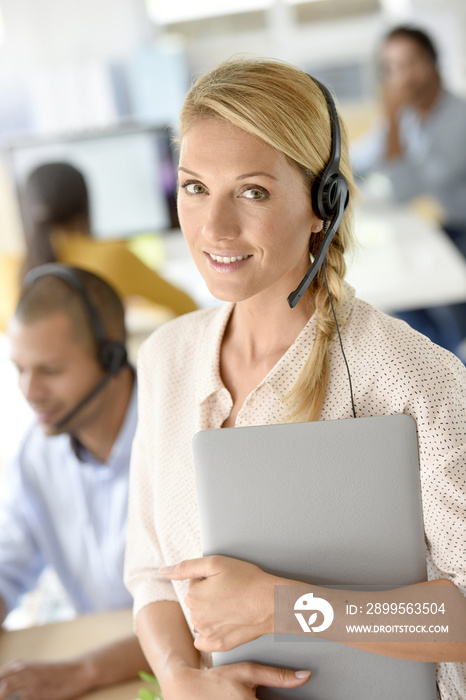 Closeup of customer service manager standing in call center