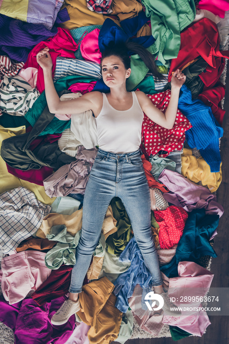 High angle above view photo of tired exhausted lady stay home general spring cleaning household lying many clothes hate mess heap stack floor pick select look outfit nothing to wear indoors