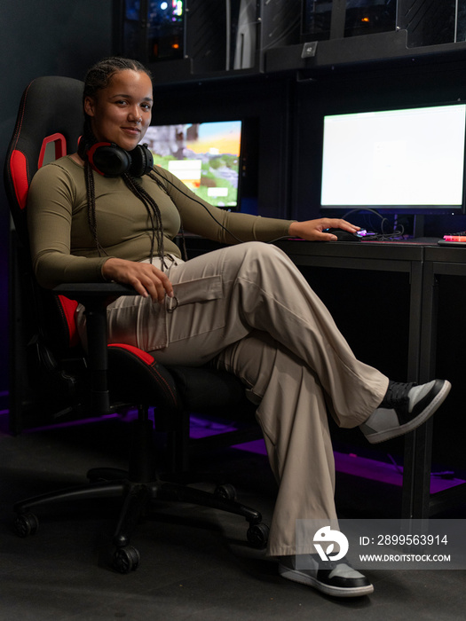 Portrait of young gamer sitting on chair