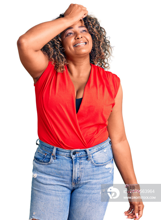 Young african american plus size woman wearing casual style with sleeveless shirt smiling confident touching hair with hand up gesture, posing attractive and fashionable