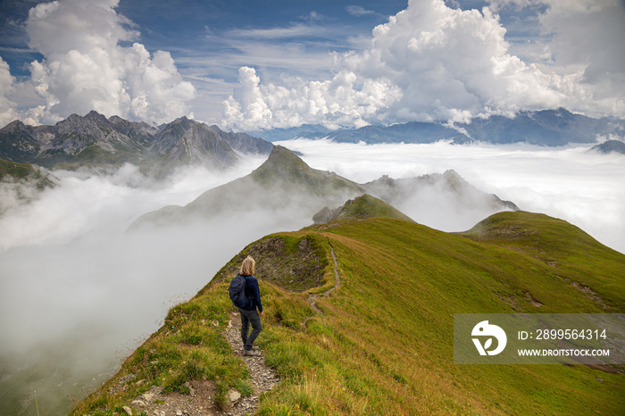 a hiker looks over the peaks of the Gehrengrat in the Lech Valley in Austria