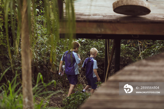 Boys going on an after school backyard adventure in their school uniforms