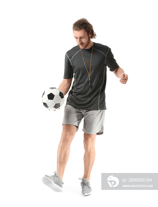 Sporty male coach with soccer ball on white background