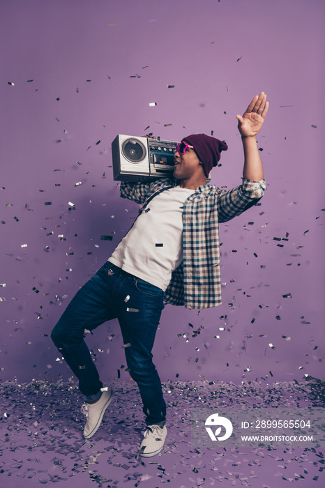 Vertical full length size body photo portrait of crazy cheerful handsome nice positive glad moving having free time carefree student enjoying loud volume isolated violet glitter background