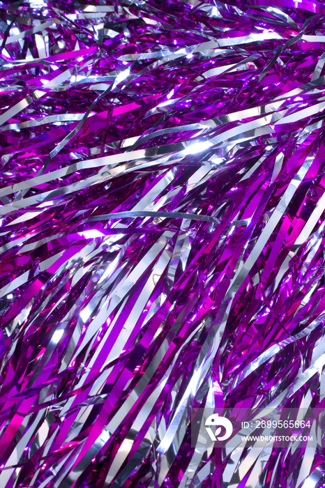 This is a closeup photograph of Cheerleader silver and purple pom poms