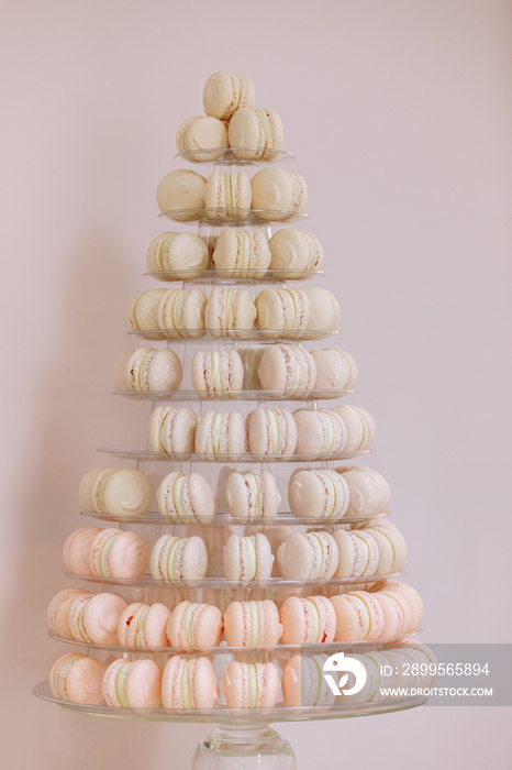 French macaroons. Candy bar. Wedding feast. Wedding sweets. beautiful macaron cake patisserie multi tier stand full of pastel macarons. pyramid tower