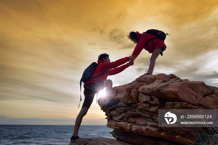 Young asian couple climbing up .