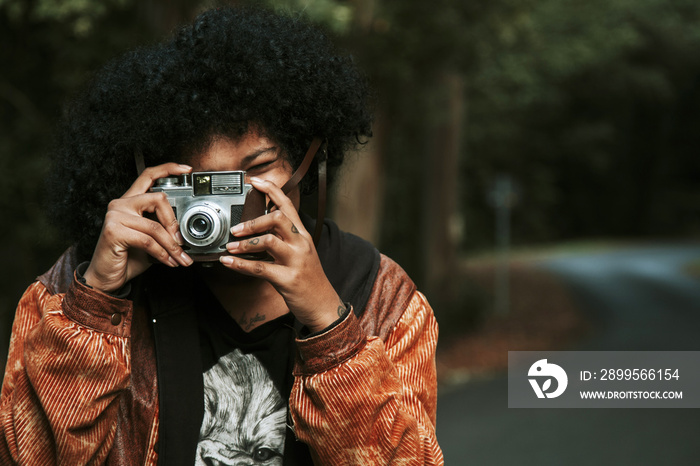 girl with vintage photo camera outdoor