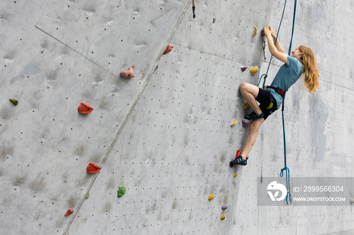 teen girl climbing up the wall