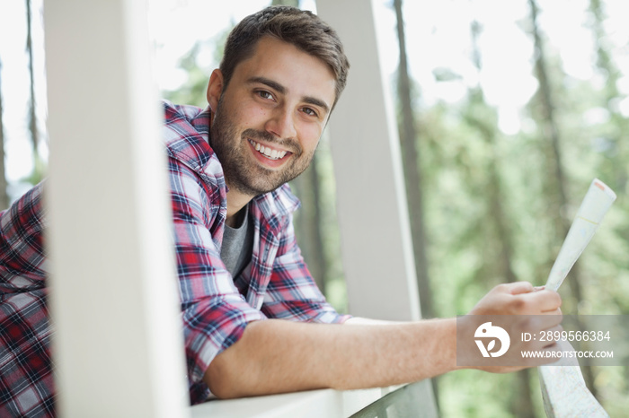 Portrait of smiling man holding map