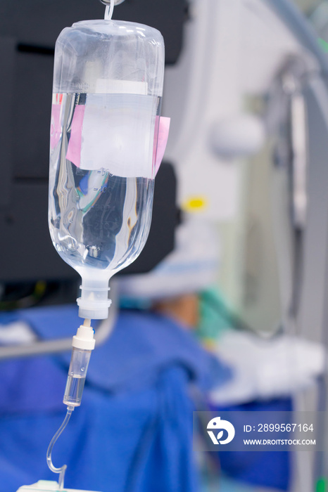 Normal saline solution or sodium chloride with infusion bottle drip for patient in hospital, Intravenous system of operating surgeons.