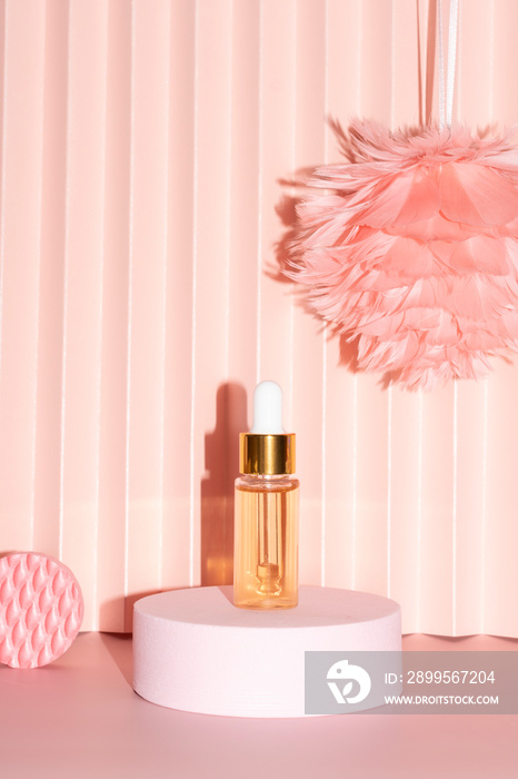 gold beauty serum in a pipette bottle on a pink podium with geometric shapes, feather flower paper fan