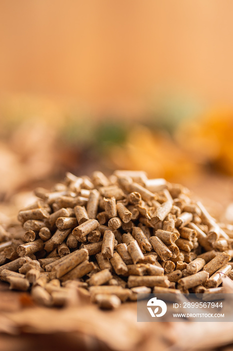 Wooden pellets on wooden table.