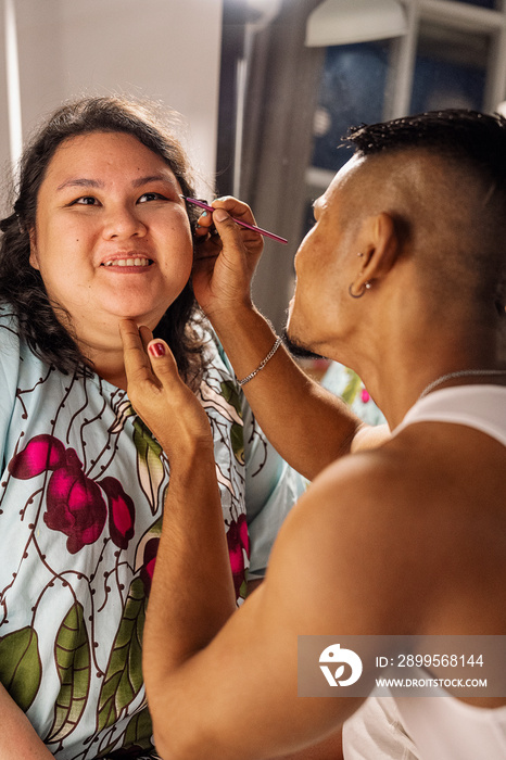 Group of friends doing each others make up at home during a sleepover