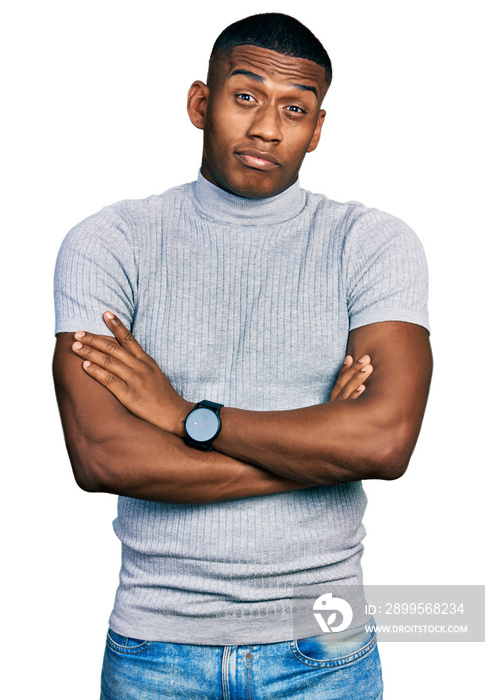 Young black man wearing casual t shirt skeptic and nervous, disapproving expression on face with crossed arms. negative person.