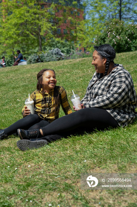 Daughter (6-7) sitting with mother in park